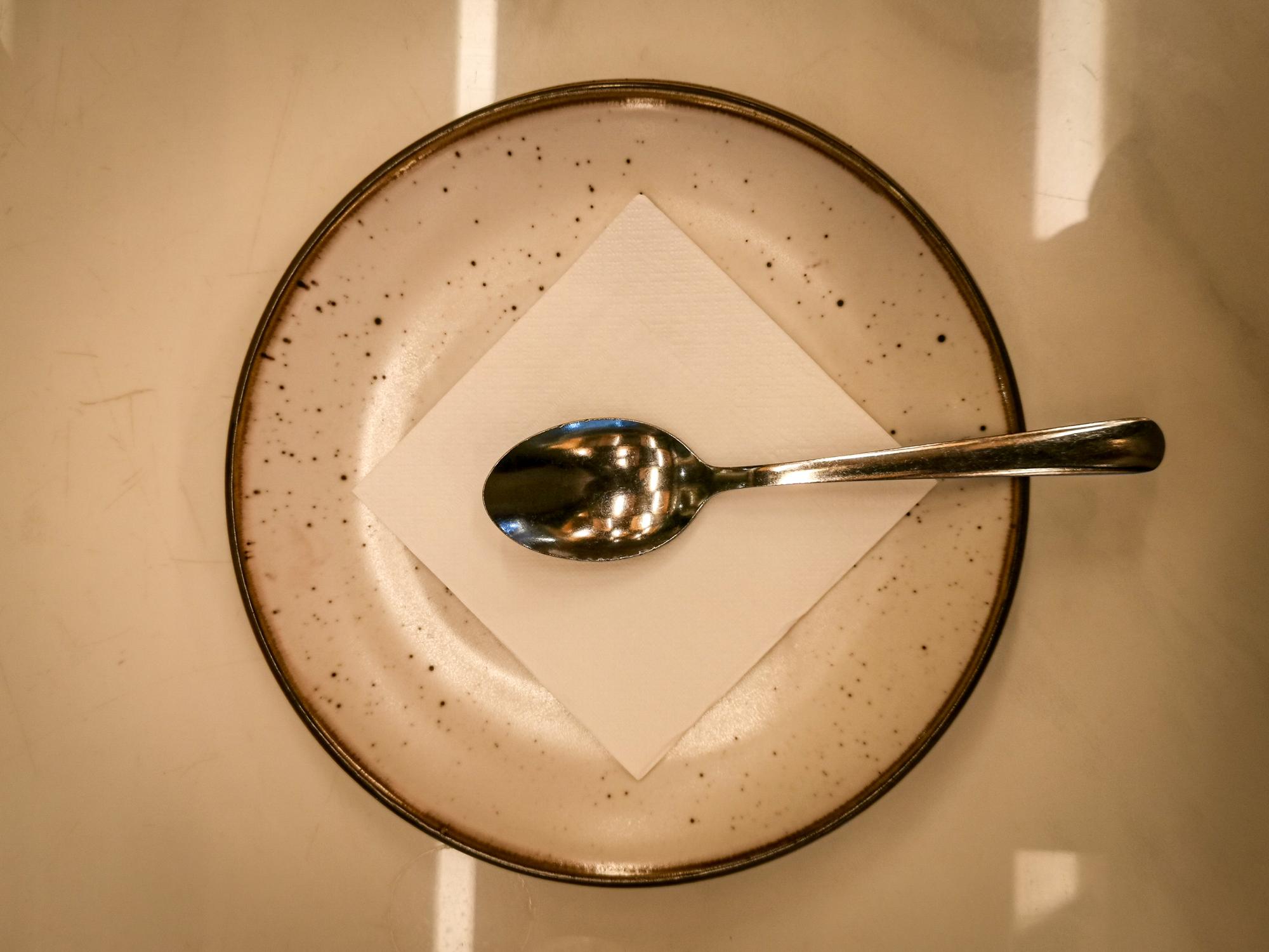Chef plating a simple composed dish on ceramic plate